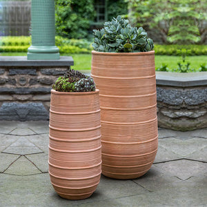 Madera Tall Planter Terra Cotta S/2 filled with plants in the backyard