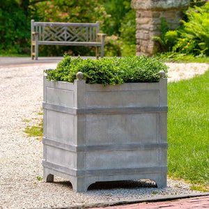 Manoir Small Planter Zinc S/1 filled with plants in the backyard