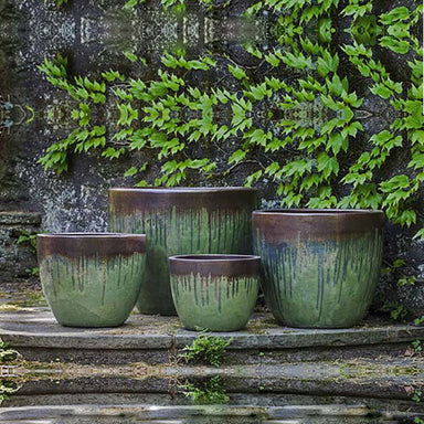 Marcel Planter Bayou Bronze S/4 on concrete against wall with leaves