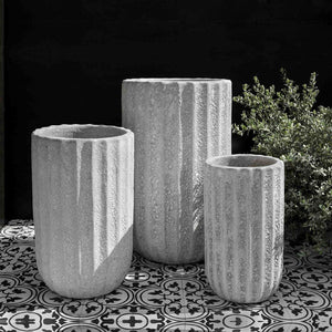 Maris Tall Planter White Coral S/3 beside green plants against black backdrop