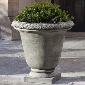 Millbridge Urn on concrete patio filled with plants