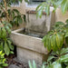 modern fountain surrounded by trees