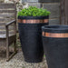 Moderne Tapered Tall Planter filled with plants beside chair