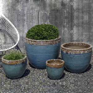 Nevis Planter - Beachcomber Aqua Set of 4 filled with plants in the backyard