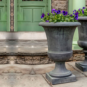 Paris Urn on concrete patio filled with flowers