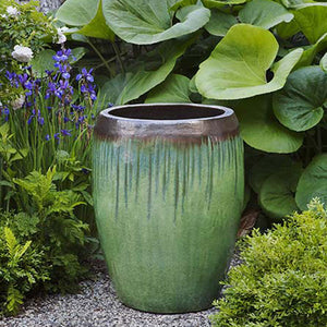 Polaris Planter - Bayou Bronze - Set of 3 surrounded with plants in the backyard