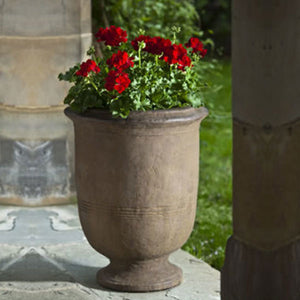 Provencal Large Urn on patio filled with red flowers