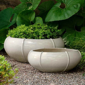 Rib Vault Planter, Low - Cream - S/2 filled with plants in backyard