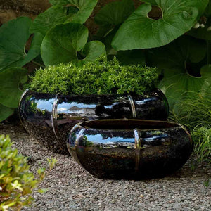 Rib Vault Planter, Low - Metallic - S/2 filled with plants in backyard