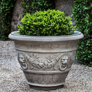 Rosecliff Planter on gravel filled with plants
