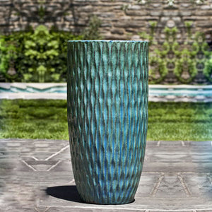 Round Palisades Planter - Weathered Copper - Set of 2 on concrete in the backyard