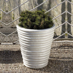 Round Ruffle Planter Antique S/3 on gravel filled with plants 
