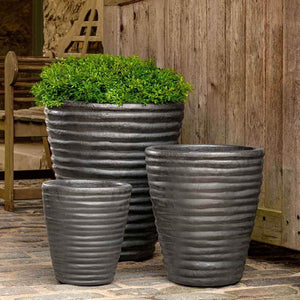 Round Ruffle Planter Graphite S/3 on concrete filled with plants 