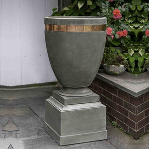 Rustic 12" Pedestal on concrete against pink flowers