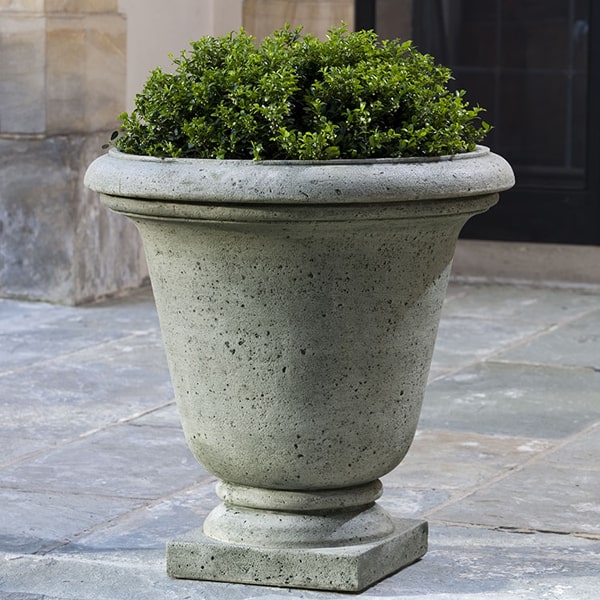 Rustic Hampton Urn on concrete patio filled with plants