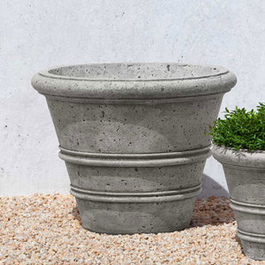 Rustic Rolled Rim 20.75 Planter on gravel in the backyard