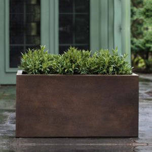 Sandal Planter 481818 - Rust Lite - S/1 on concrete filled with plants
