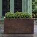 Sandal Planter 481818 - Rust Lite - S/1 on concrete filled with plants