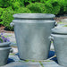 Scroll Handle Large Planter on stone against green plants 