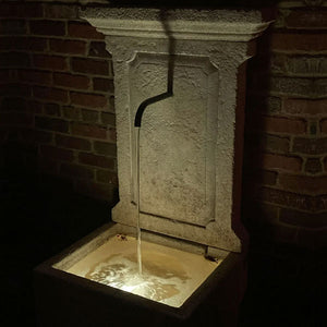 single led light shining in fountain basin at night