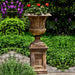 Smithsonian Classical Urn filled with red flowers in the backyard