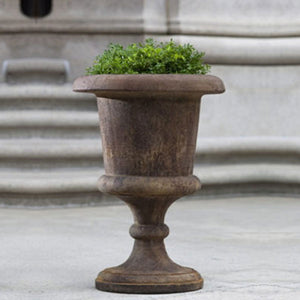 Smithsonian Goblet Urn on concrete filled with plants