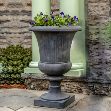 Soane Urn filled with purple flowers in the backyard