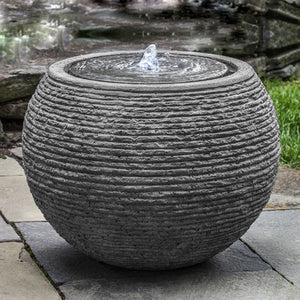 large sonora fountain in black stone ledge in action