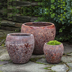 Symi Planter - Angkor Red - Set of 3 on concrete in the backyard