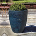 Tall Sisal Weave Planter Indigo Rain filled with plants in the backyard 