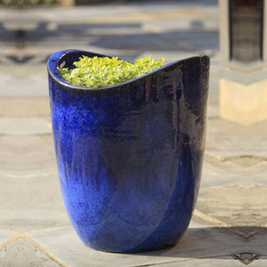Tall Sorriso Planter - Riviera Blue S/3 on concrete filled with plants