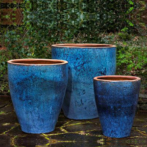 Tharabar Planter - Rustic Blue Set of 3 against plants in the backyard