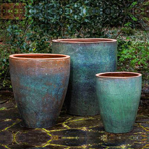 Tharabar Planter - Rustic Green Set of 3 against plants in the backyard