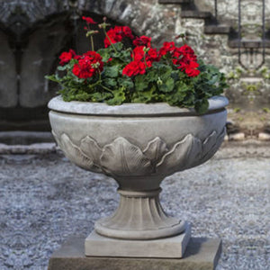 The Elms Urn filled with red flowers against concrete stairs