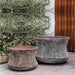 Thira Planter Aegean S/2 on concrete beside green plants