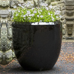 Timolos Rnd Planter - Cola - S/3 filled with white flowers in the backyard