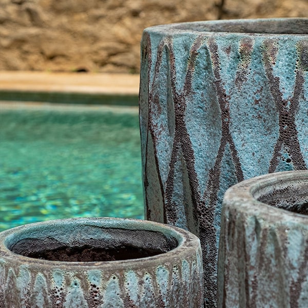 Tortona Planter Verdigris S/3 on concrete near a swimming pool upclose