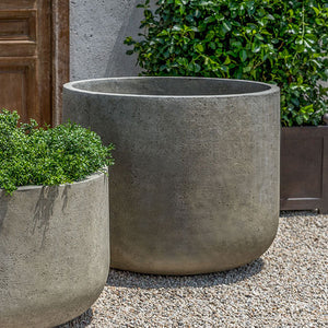 Tribeca Planter, Extra Large on gravel beside a planter that filled with plants upclose