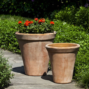 Usuki Planter - Terra Cotta S/2 filled with red flowers in the backyard