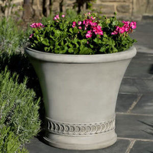 Vallier Planter on concrete patio filled with flowers