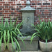 vence wall fountain against red brick wal