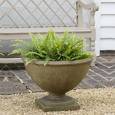 Williamsburg Bassett Hall Urn on gravel near a bench