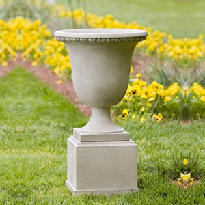 Williamsburg Egg and Dart Urn Planter on grass in the backyard