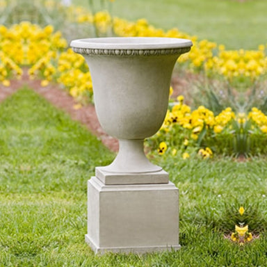 Williamsburg Egg and Dart Urn Planter on grass in the backyard