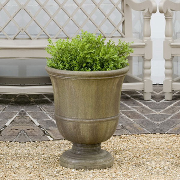 Williamsburg Orangery Urn on gravel near a bench