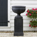 Williamsburg Plantation Urn on gravel near a flower plant