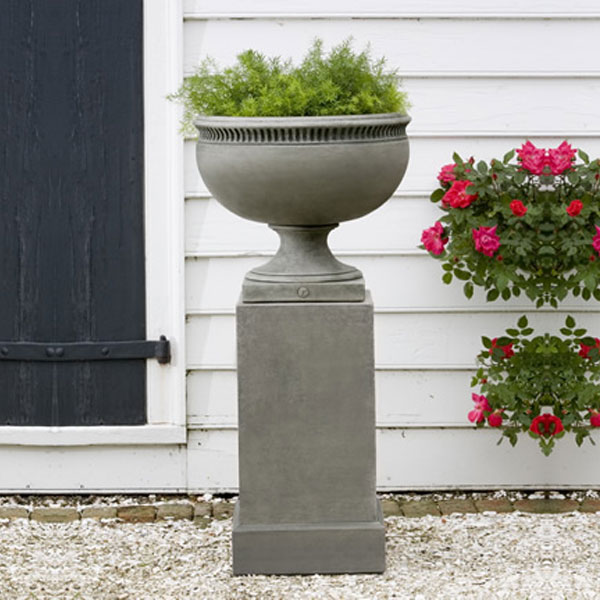 Williamsburg Tayloe House Urn on gravel near a flower plant